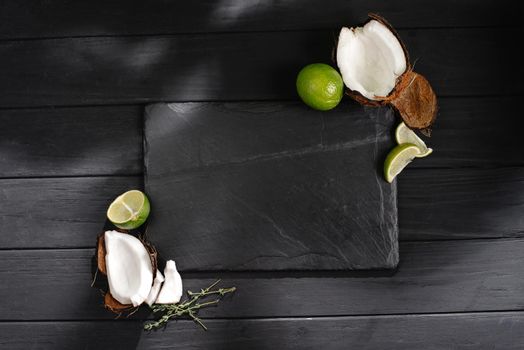 mock up slate with tropical fruits coconuts and lime.