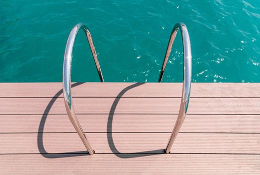 floating dock with composite deck and ladder at the marina.