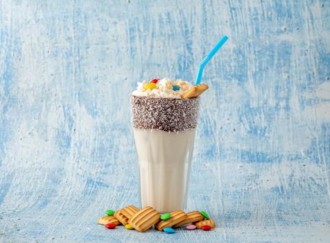 Milkshake with milk and baby biscuit decorated with dragee sugar.