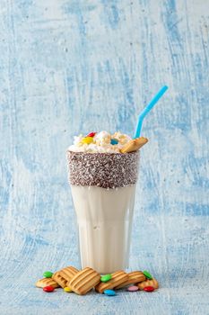 Milkshake with milk and baby biscuit decorated with dragee sugar.