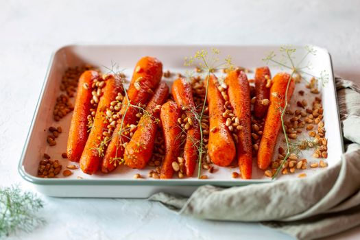 Lebanese-style carrots prepared with pine nuts and cumin and decorated with dill