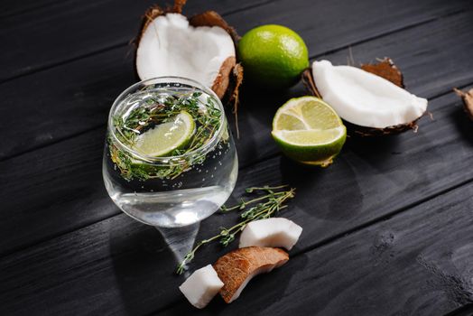 Coconut cocktail on a dark wooden background. coconut water with lime.