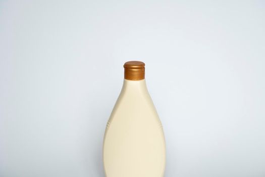 Beige blank plastic bottles isolated on white background