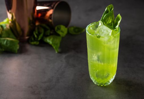 refreshing and light basil summer cocktail with ice cubes