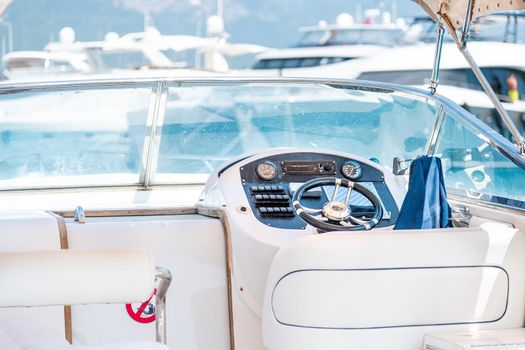 Steering wheel on expensive luxury yacht cabin. Detail of the interior of yacht.