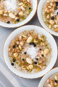 Traditional Turkish Dessert is Asure "Noah's Pudding" on wooden background