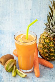 Refreshing and energizing orange juice with kiwi, pineapple and carrots