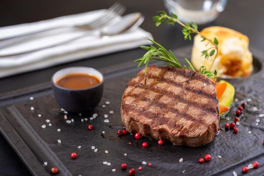 Grilled beef. Tenderloin steak on stone plate with grilled vegetables. Filet Mignon concept.