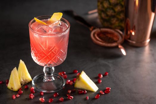 refreshing and light pomegranate and pineapple summer cocktail with ice cubes