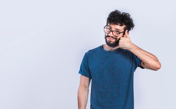Person making call gesture with fingers. Handsome man imitating a phone conversation, Young man making call gesture on isolated background