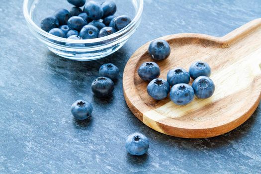 Blueberries on a wooden table. Fresh berries. Wild blueberries on a wooden stand. Copyspace.