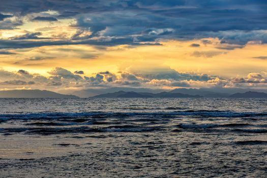 Evening view of the Pacific Coast of Tarcoles in Carara with sunset and glittering waves . Idyllic sunset landscape. Tarcoles, Costa Rica. Pura Vida concept, travel to exotic tropical country.