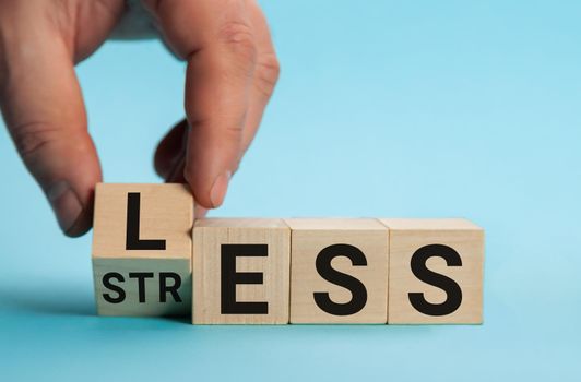 Having less stress or being stress-less. The word on wooden cubes. The concept of having less stress or being stress-less in letters. Business and psychological.