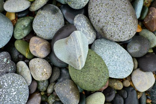 Pebble beach stones background, natural large rounded gravel on the seashore nature background texture pattern