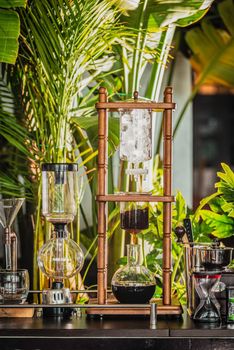 cold drip coffee tower with soft-focus and over light in the background