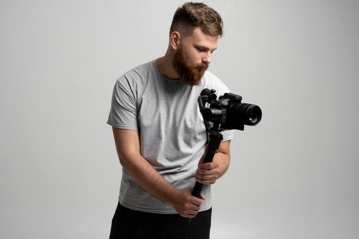 Professional content creator with a dslr camera on 3-axis gimbal stabilizer. Filmmaking, videography, hobby and creativity concept