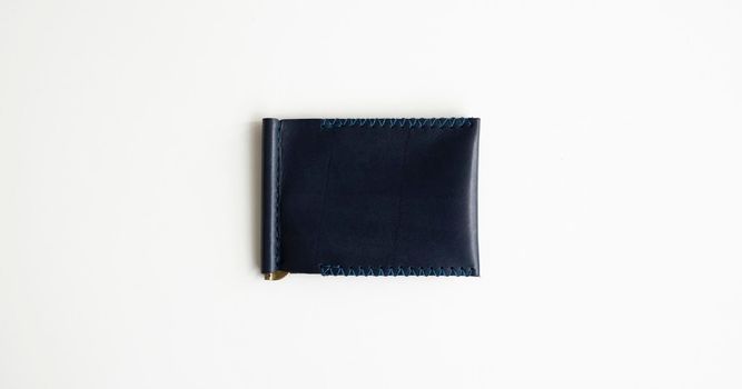 Blue money clip handmade from genuine leather on white surface