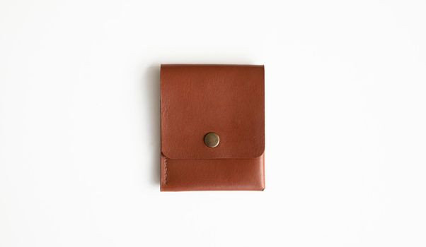 Orange genuine leather card holder on a white surface