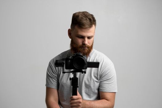 Professional filmmaker with a dslr camera on 3-axis gimbal stabilizer. Filmmaking, videography, hobby and creativity concept