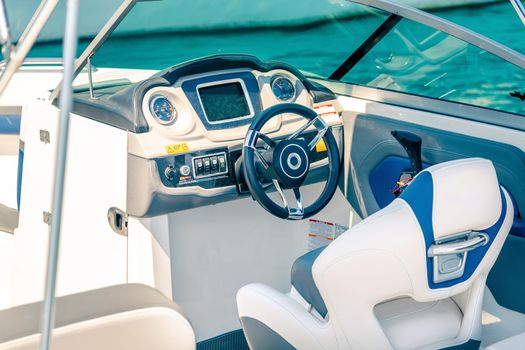 Steering wheel on expensive luxury yacht cabin. Detail of the interior of yacht.