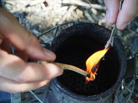 starting a bee smoker before harvesting honey hives in the farm.