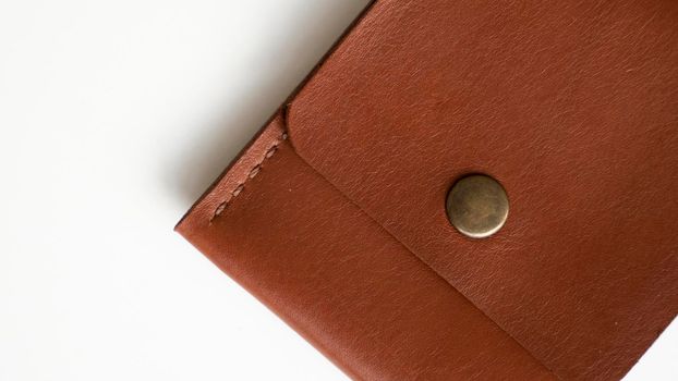 Orange genuine leather card holder on a white surface