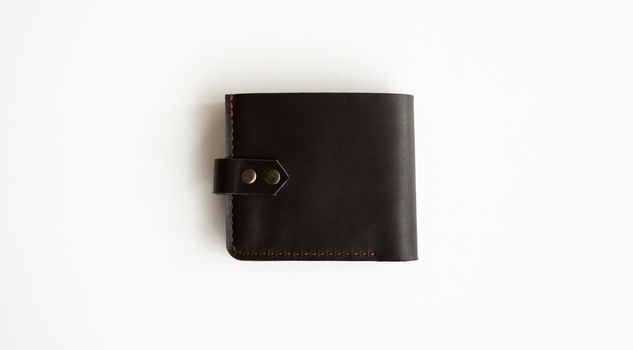 Brown natural genuine leather wallet isolated on white background. Expensive man's purse closeup