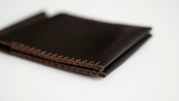 Brown money clip handmade from genuine leather on white surface