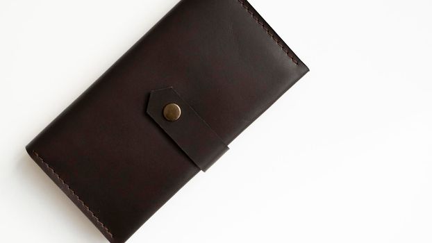 Brown natural genuine leather wallet isolated on white background. Expensive man's purse closeup