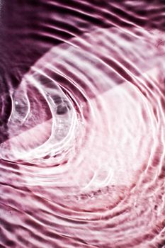 Pink flowing water texture as an abstract background - colourful liquids and creative designs concept. Pink flow