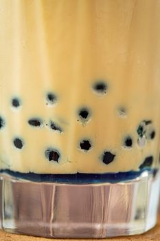 Fruity Bubble Tea in glass cup on wooden background