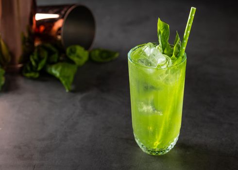 refreshing and light basil summer cocktail with ice cubes