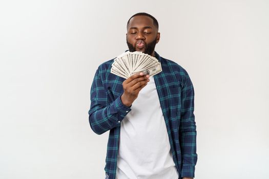 African man holding bank notes happy and surprised cheering expressing wow gesture