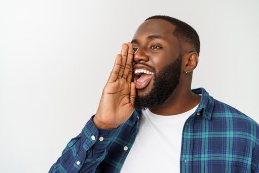 Young Afro-American man shouting. Shout. Emotional man screaming. Human emotions, facial expression concept