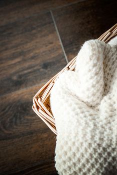 Knitwear, fabric textures and rustic lifestyle concept - Knitted winter clothes in a basket