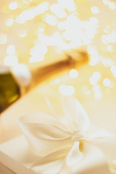 Romantic celebration, lifestyle and luxury present concept - The bottle of champagne and holiday gift box