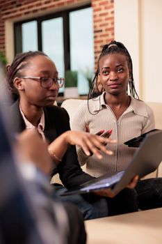 African american people doing business teamwork in startup office, meeting to work on company presentation with research information and report. Working on partnership collaboration.