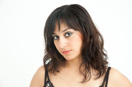 Pretty brunette girl with long hair looking at camera on white background, close up