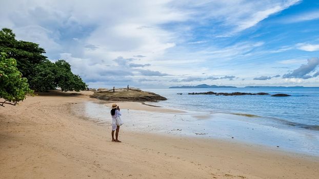 Wong Amat Beach North Pattaya, is a beautiful beach in Thailand. Asian women walking on the beach