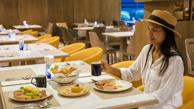 Asian women having a Breakfast buffet in a luxury hotel.