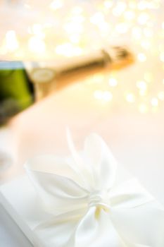 Romantic celebration, lifestyle and luxury present concept - The bottle of champagne and holiday gift box