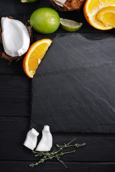 Mockup Set of fruits tropical lime, coconut on, orange, the background of an old dark wooden table, top view, flat.