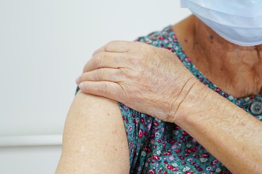 Asian elder senior woman patient getting coronavirus vaccine.