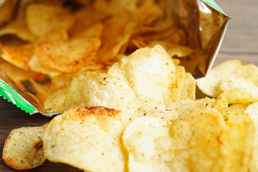 Potato chips in open bag, delicious BBQ seasoning spicy for crips, thin slice deep fried snack fast food in open bag.