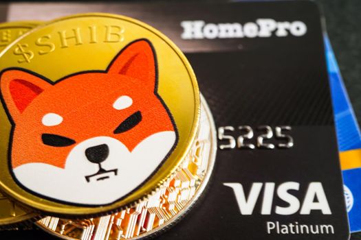 Bangkok, Thailand - December 15, 2021 Golden bitcoin with credit card on US dollar banknotes money for business and commercial, Digital currency, Virtual cryptocurrency.