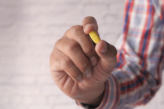 hand holding pills with copy space .