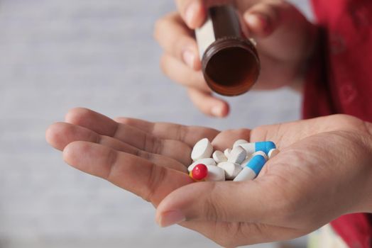Close up of women hand taking pills.