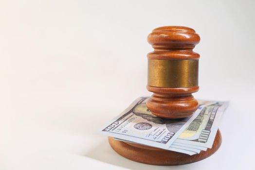 close up of gavel and cash on white background with copy space, side view