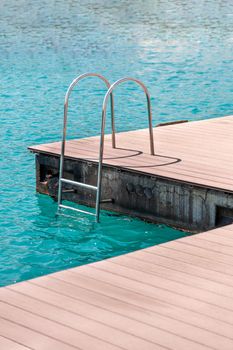 floating dock with composite deck and ladder at the marina.