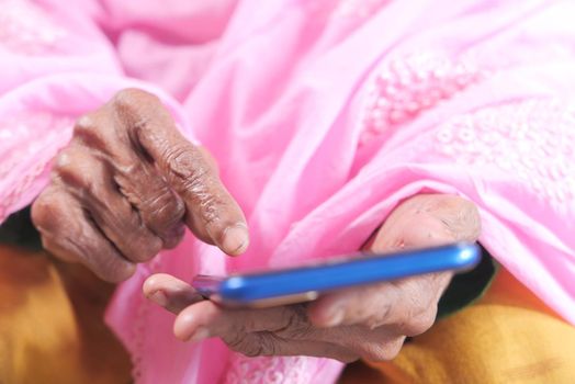 senior women hand using smart phone close up .